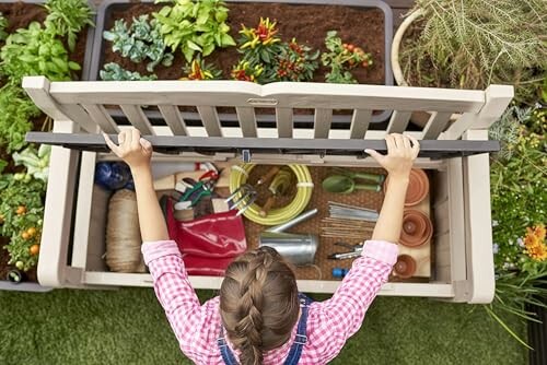 Child opening a garden storage box with plants and tools.