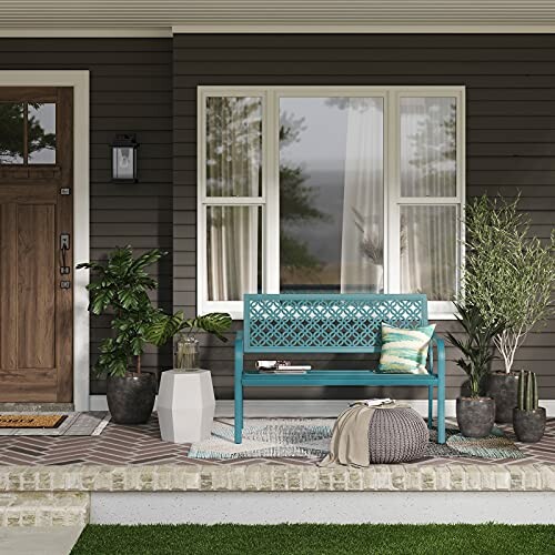 Entryway with a blue bench, pillows, coat hooks, and decor.