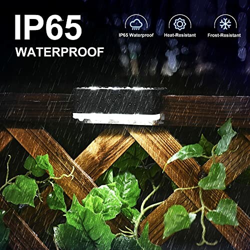 Outdoor waterproof light on wooden fence with raindrops