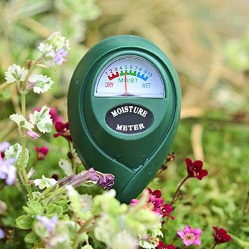 Soil moisture meter in a garden with flowers.