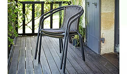 Stacked outdoor chairs on a wooden balcony.